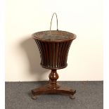 A 19th Century mahogany jardinière stand of urn form on a platform base,