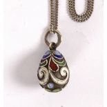 A Russian silver and enamel egg form pendant decorated scrolls and dots in coloured enamels,