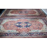 A pair of Isfahan rugs of all over stylised design on a camel coloured ground,