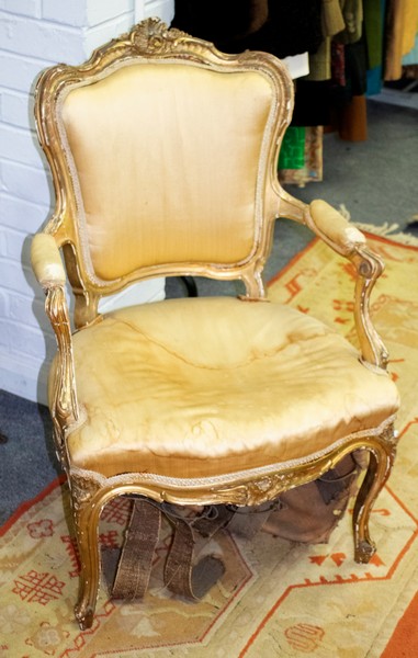 A Louis XVI style fauteuil with upholstered seat and padded arms on cabriole legs