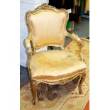 A Louis XVI style fauteuil with upholstered seat and padded arms on cabriole legs