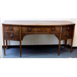 An early 19th Century mahogany bowfront kneehole sideboard with one shallow drawer and two deep