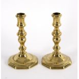 A pair of French brass candlesticks, early 18th Century,