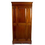 A mahogany wardrobe with central panel door,