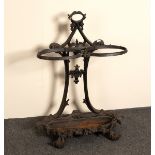 A cast iron umbrella stand with pierced decoration, division and base,
