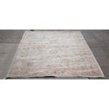 A Persian rug of Ziegler design, decorated scrolling foliage to a camel ground,