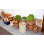 A large quantity of terracotta planters and stands and two Gothic tracery wall panels