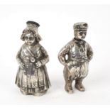 A pair of Dutch 800 standard silver pepper pots, modelled as a boy and a girl, circa 1880,