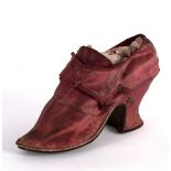 An 18th Century single silk crimson shoe with leather sole,