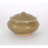 An early Ming celadon glaze circular pot and cover,
