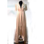 A cream satin button through long dress with lace trim, a long multi-floral,
