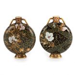A pair of unusual Japanese Satsuma moon flasks, painted with flowers on a blue/green scroll ground,