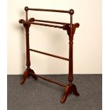 A Victorian towel rail on fluted supports united by a turned stretcher,
