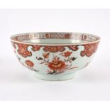 A Chinese bowl, painted chrysanthemums and peony in iron red and gilt,