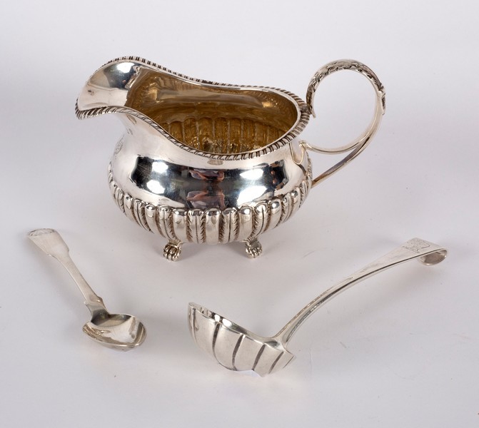 An Irish silver jug, James le Bas, Dublin 1826, with gadrooned rim and half-ribbed body, crested,