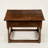 An 18th Century oak side table (cut down) fitted a single drawer on turned legs,