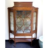 An Edwardian inlaid cabinet on square taper legs,