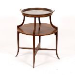 An Edwardian mahogany circular two-tier table, with platform base and splay feet,