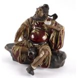 A Chinese pottery figure by Liu Zemian of Zhong Kui drinking wine,