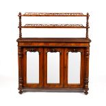 A Regency rosewood chiffonier with shelves over, enclosed by three mirror doors,