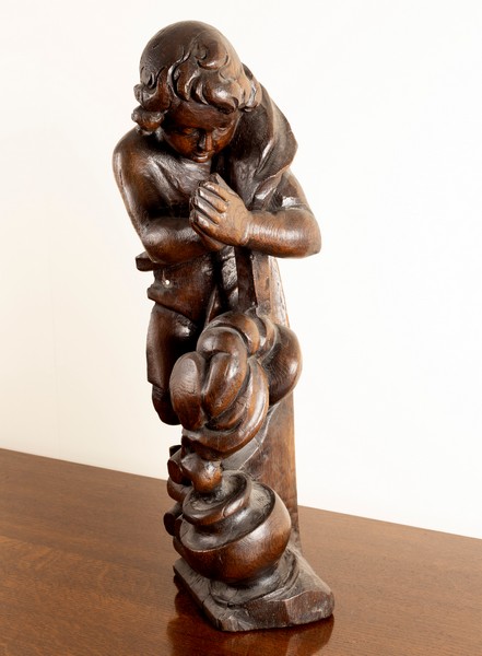 A carved oak wooden figure of a boy by a cooking pot, - Image 2 of 2