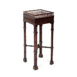 A Chippendale style mahogany square jardinière stand with gallery and raised on cluster column