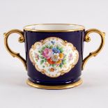 A Plant Tuscan China loving cup in dark blue glaze with floral painted panel to each side,