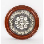 A circular mirror with engraved glass surround, the plate with nine concave roundels,
