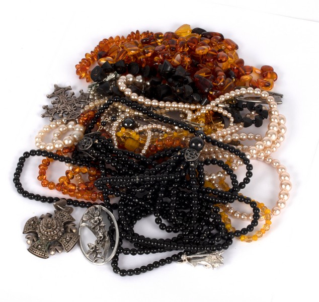 A quantity of costume jewellery including amber bead necklaces, faux pearls, marcasite etc.