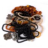 A quantity of costume jewellery including amber bead necklaces, faux pearls, marcasite etc.
