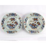 A pair of Chinese Imari style plates in overglaze blue enamels painted with birds amongst peonies