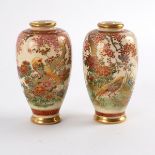 A pair of Japanese Satsuma bottle vases, painted in polychrome with pheasant in landscapes,