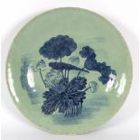 A Chinese celadon plate with water lily decoration in underglaze blue,