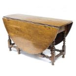 An 18th Century oak two-flap table, on bobbin turned legs and stretchers,