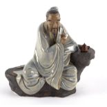 A Chinese pottery figure by Liu Zemian of Lu Yu tasting tea,