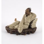 A Chinese pottery figure by Liu Zemian of Zhuangzi, dreaming he became a butterfly,