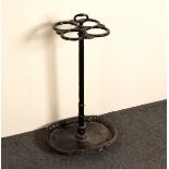 A cast iron stick stand, the four apertures to a central support set on an oval base,