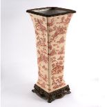 A continental ceramic square tapering vase with fluted corners,