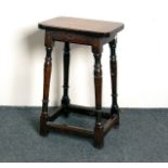 An oak stool on turned legs,