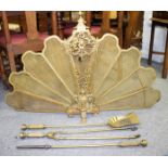 A pierced brass nine-section, fan-shaped fire guard,