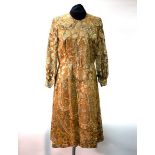 A Mary Donan dress in a paisley lurex design with matching wide brim hat by Simone Mirman,