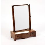 A George III mahogany swing frame toilet mirror with serpentine three drawer base,