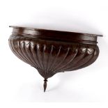 A carved walnut canopy finial of reeded coronet form,