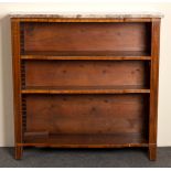 A Regency rosewood bookcase with marble top and grilles to the sides,