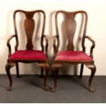 A pair of oak armchairs of George I design with solid splat backs and loose trap seats,