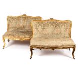 A pair of French 19th Century giltwood framed two-seater settees,