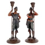 A pair of figural candlesticks, the supports in the form of pike men,