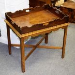 A butler's mahogany tray with pierced handle to each side, on a stand,