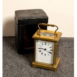 A gilt brass cased carriage clock, the white enamel dial with Roman numerals,