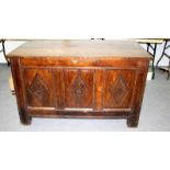 An 18th Century oak coffer, the triple-panel front with carved lozenges, on block feet, 135.